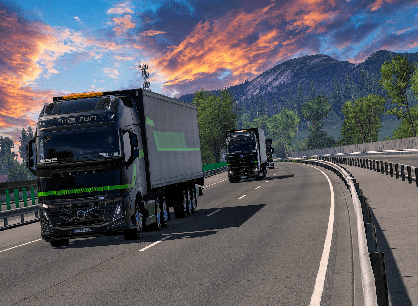 Trucks travelling along a highway at sunset.